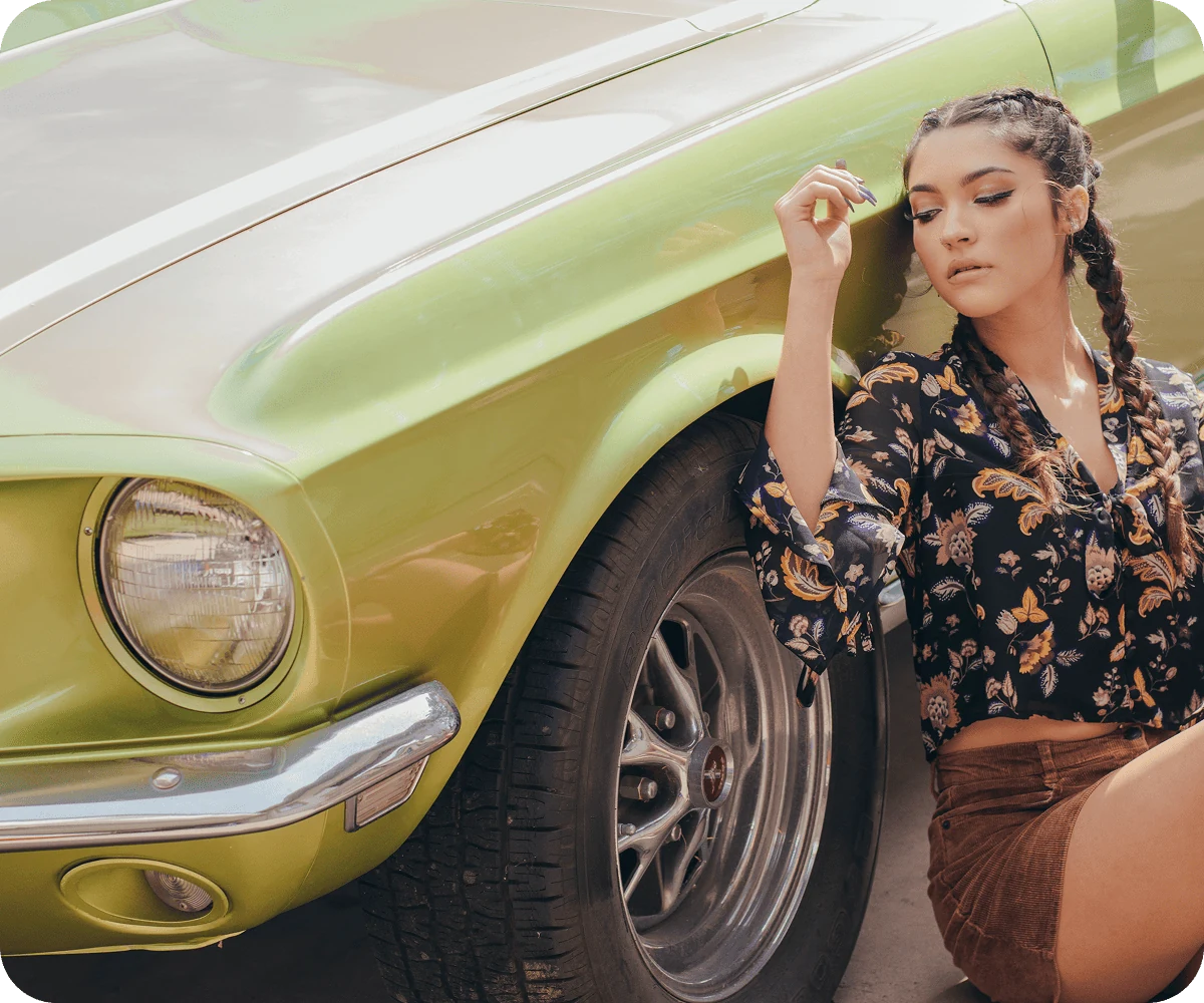 Woman beside a green classic car